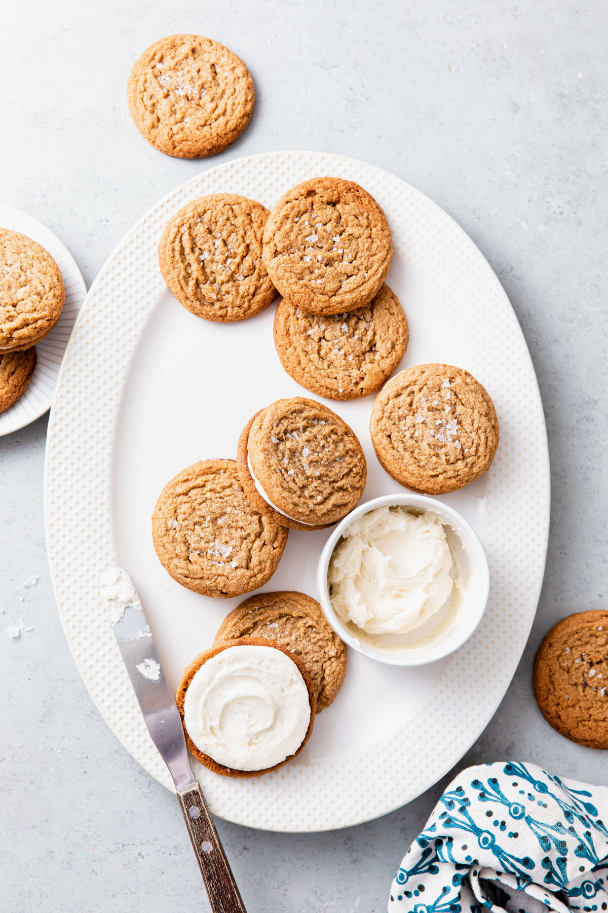 Assembling Flourless Peanut Butter Cookies and spreading on whipped vanilla frosting filling