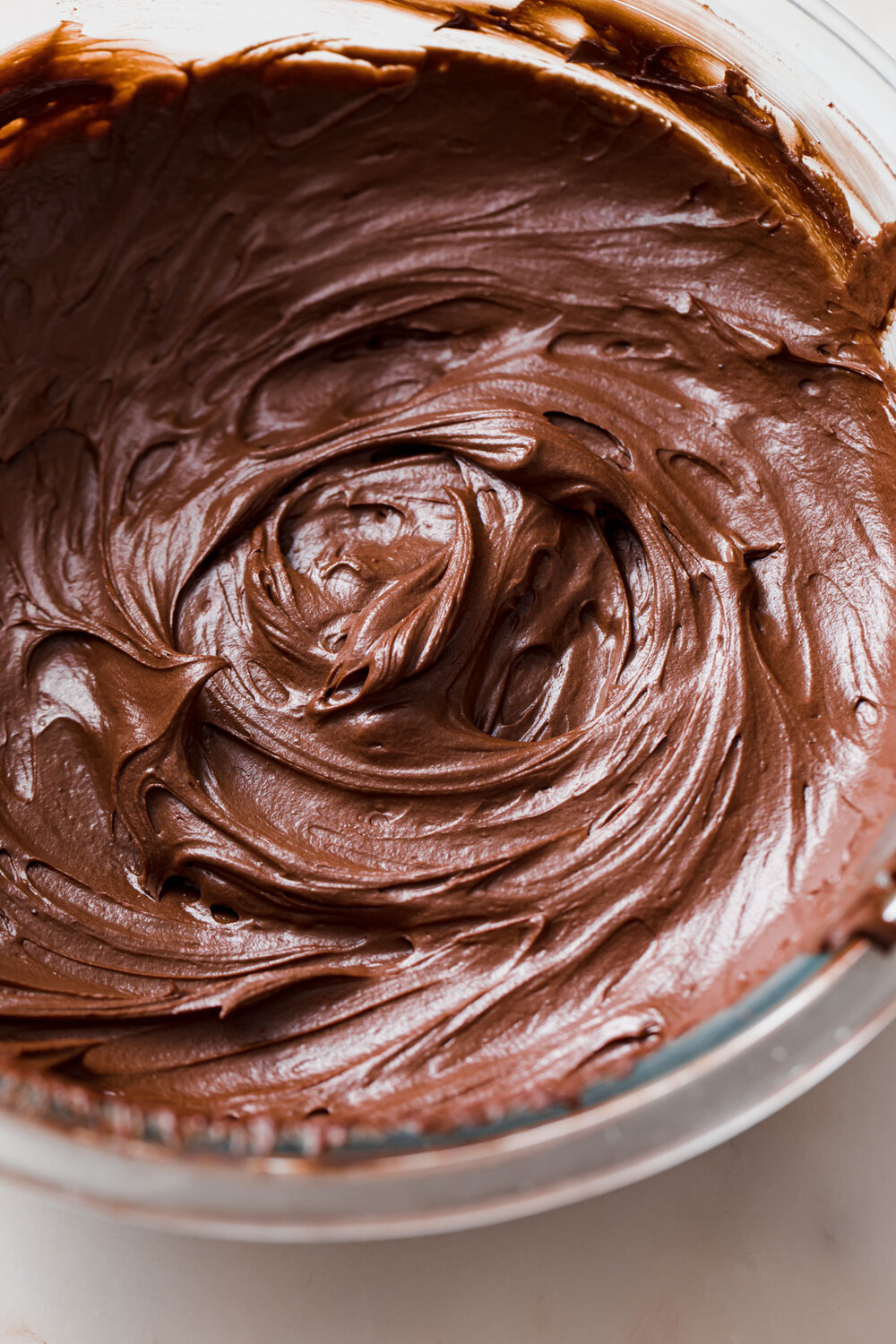 A look inside a bowl of freshly whipped chocolate ganache frosting.