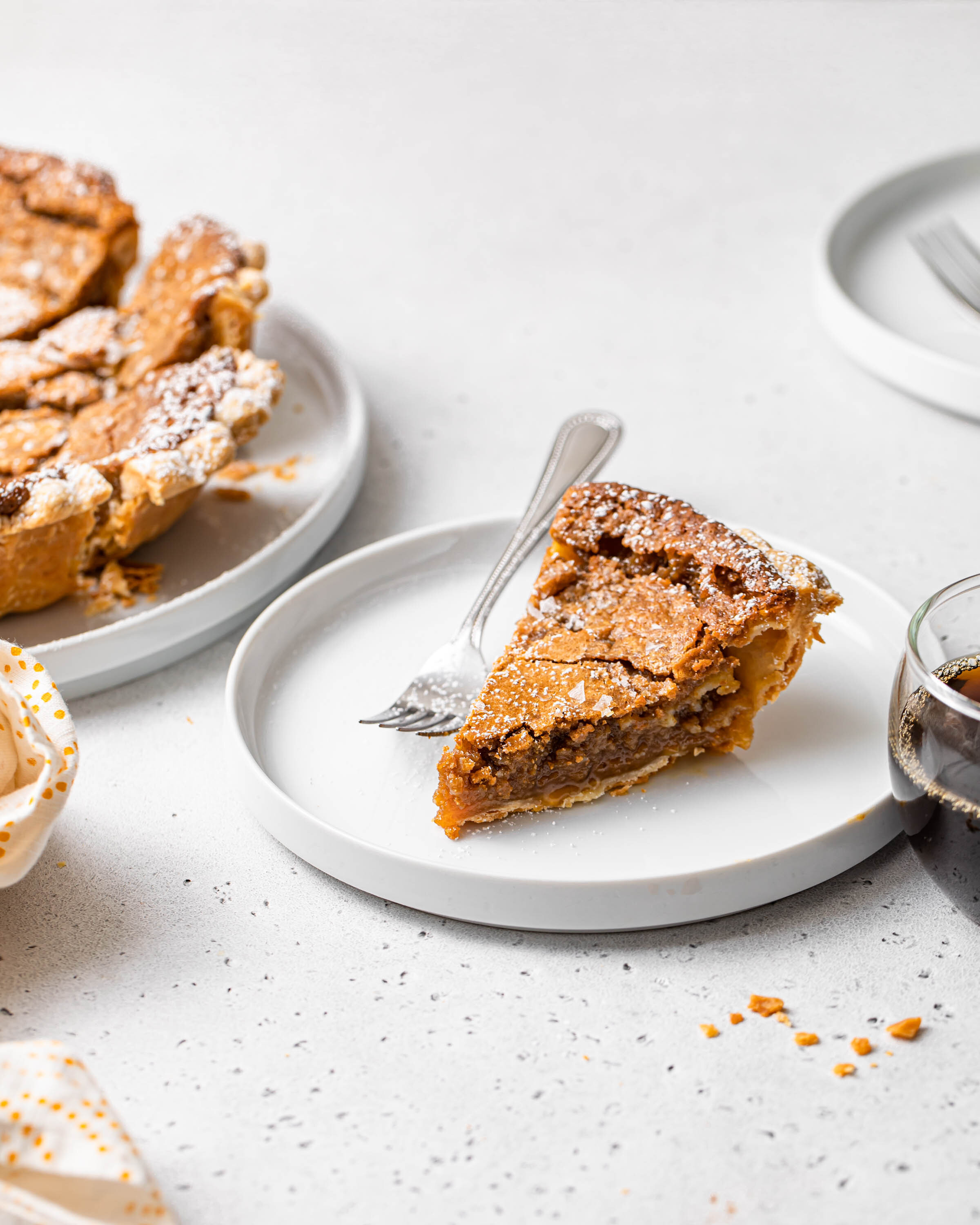 Slice of maple sugar pie with flaky crust and gooey brown sugar filling.