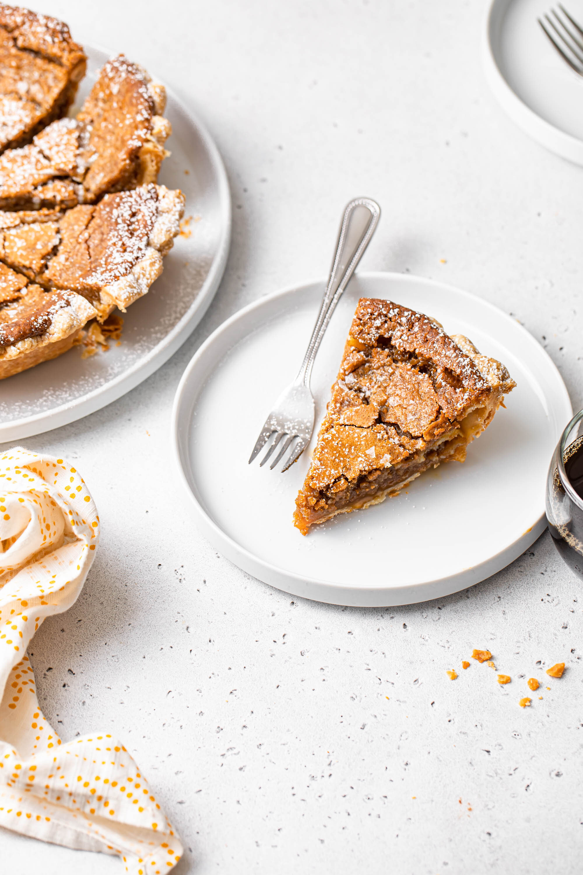 A slice of French Canadian Maple Sugar Pie with a gooey, brown sugar filling and crispy top.