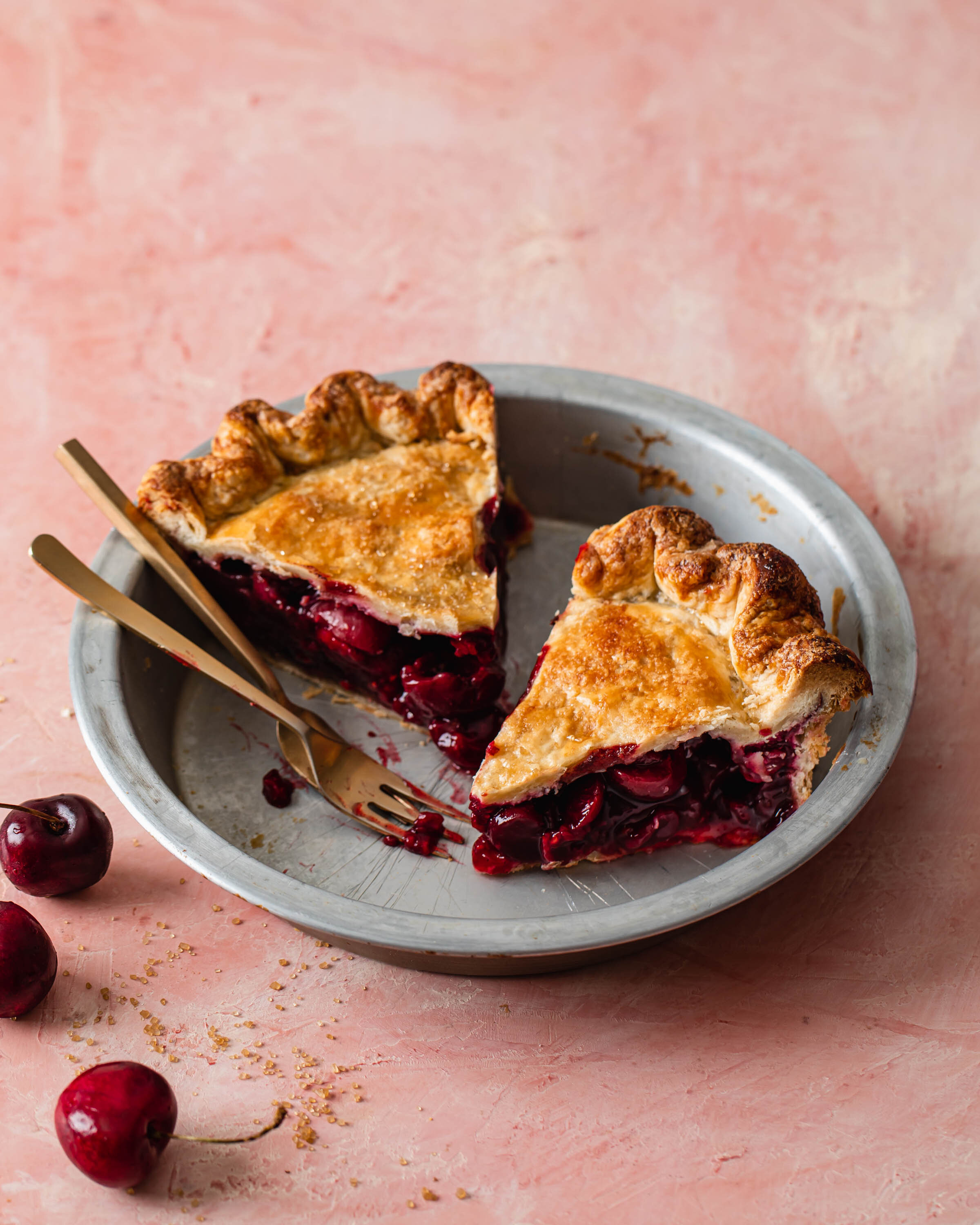 Two slices of homemade cherry pie with bright sweet cherry filling and flaky,  all-butter crust