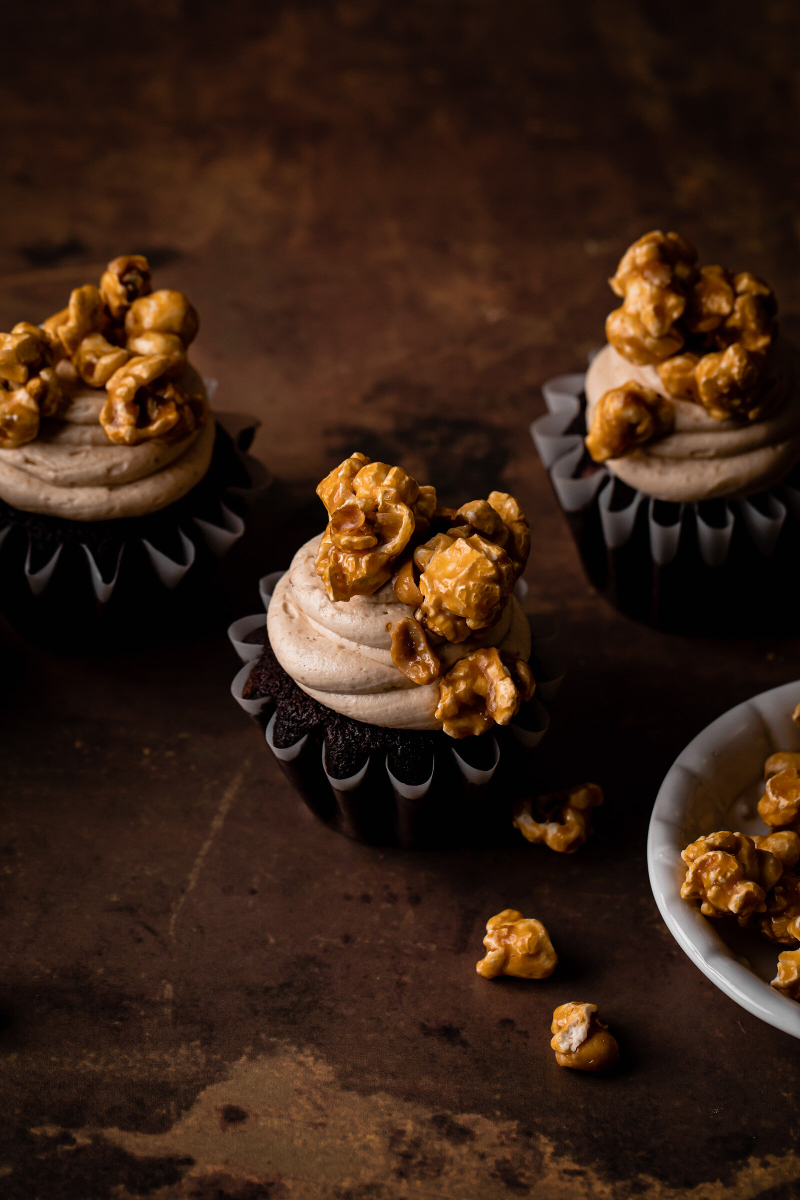 Devil's Food Cupcakes with peanut butter frosting and caramel corn topping