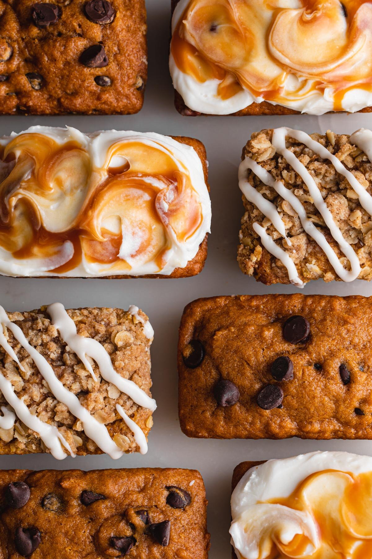 An overhead, close-up picture of three different pumpkin mini loaf cakes.