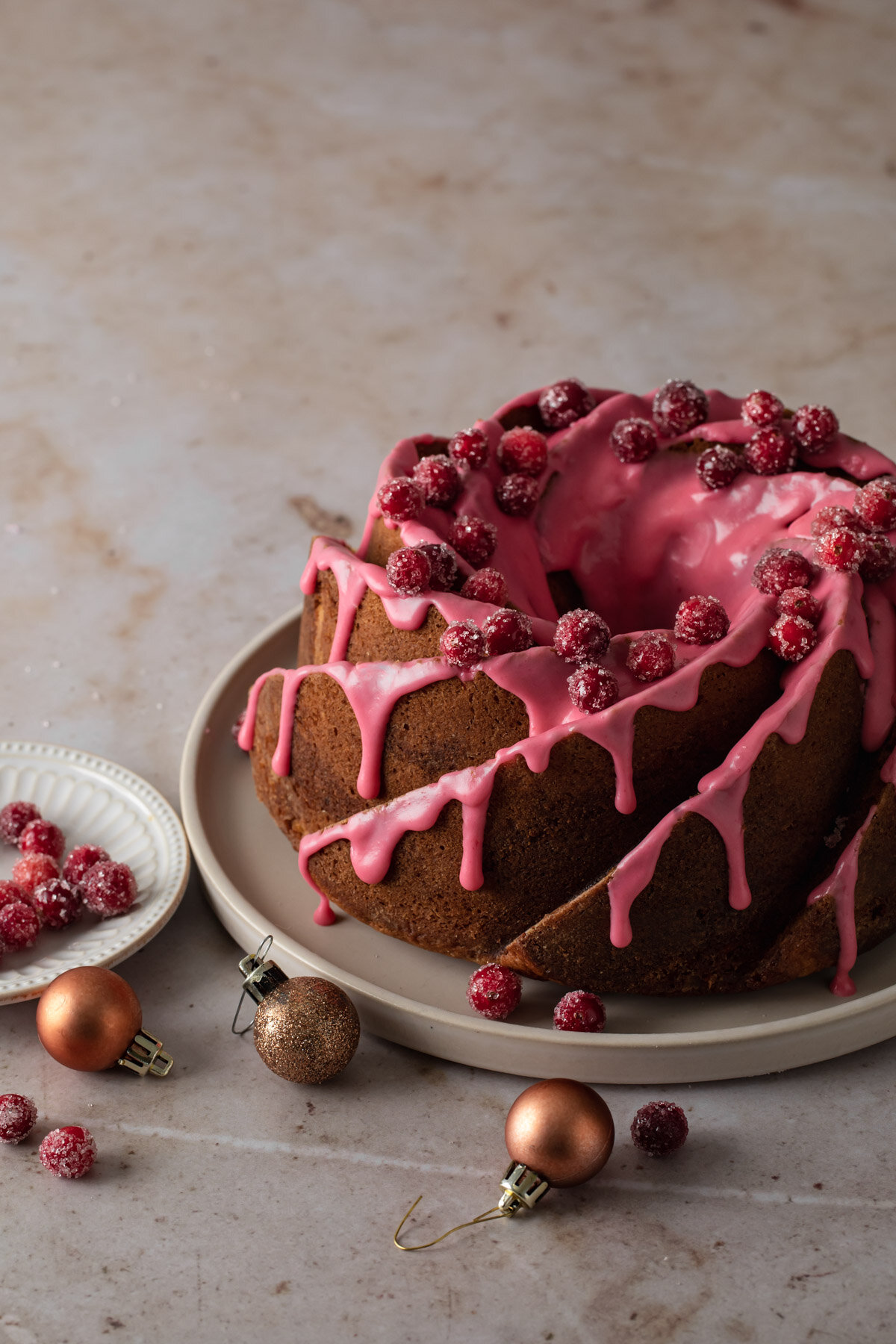 Cinnamon Swirl Bundt Cake with cranberry glaze and sugared cranberries