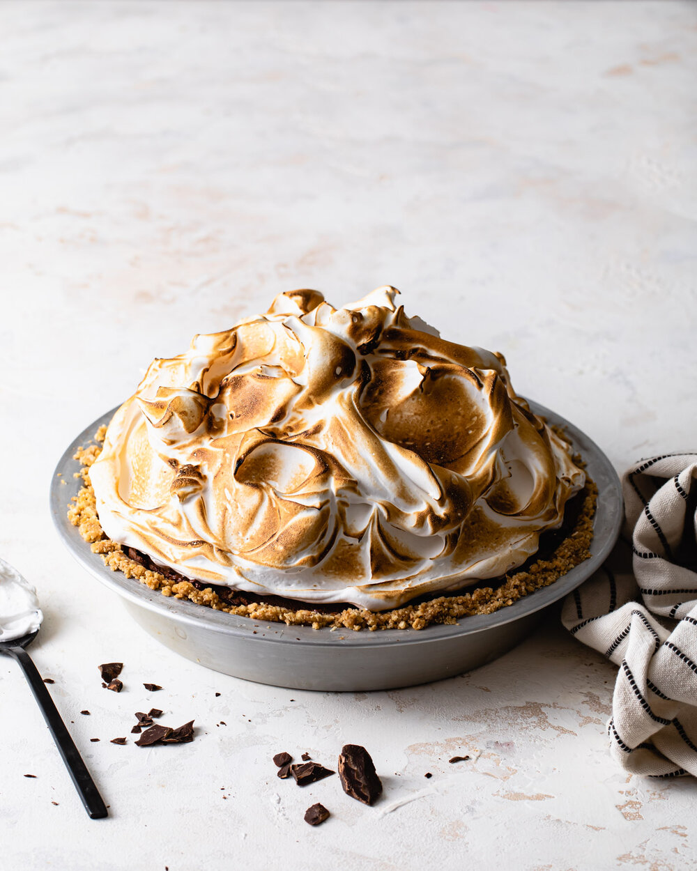 Peanut butter s’mores pie with chocolate peanut butter mousse filling and toasted meringue on top.