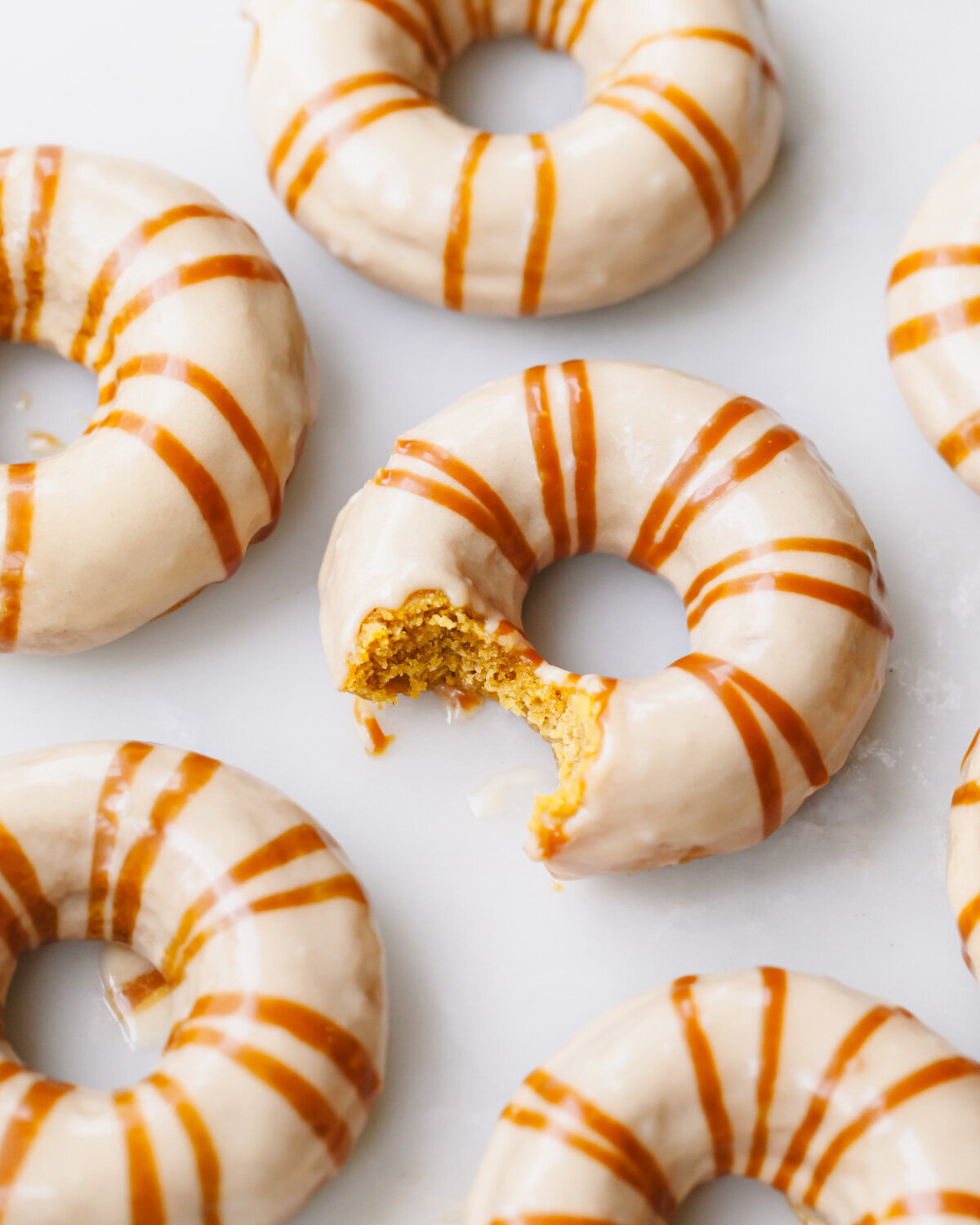 Baked pumpkin donuts with caramel glaze on top.