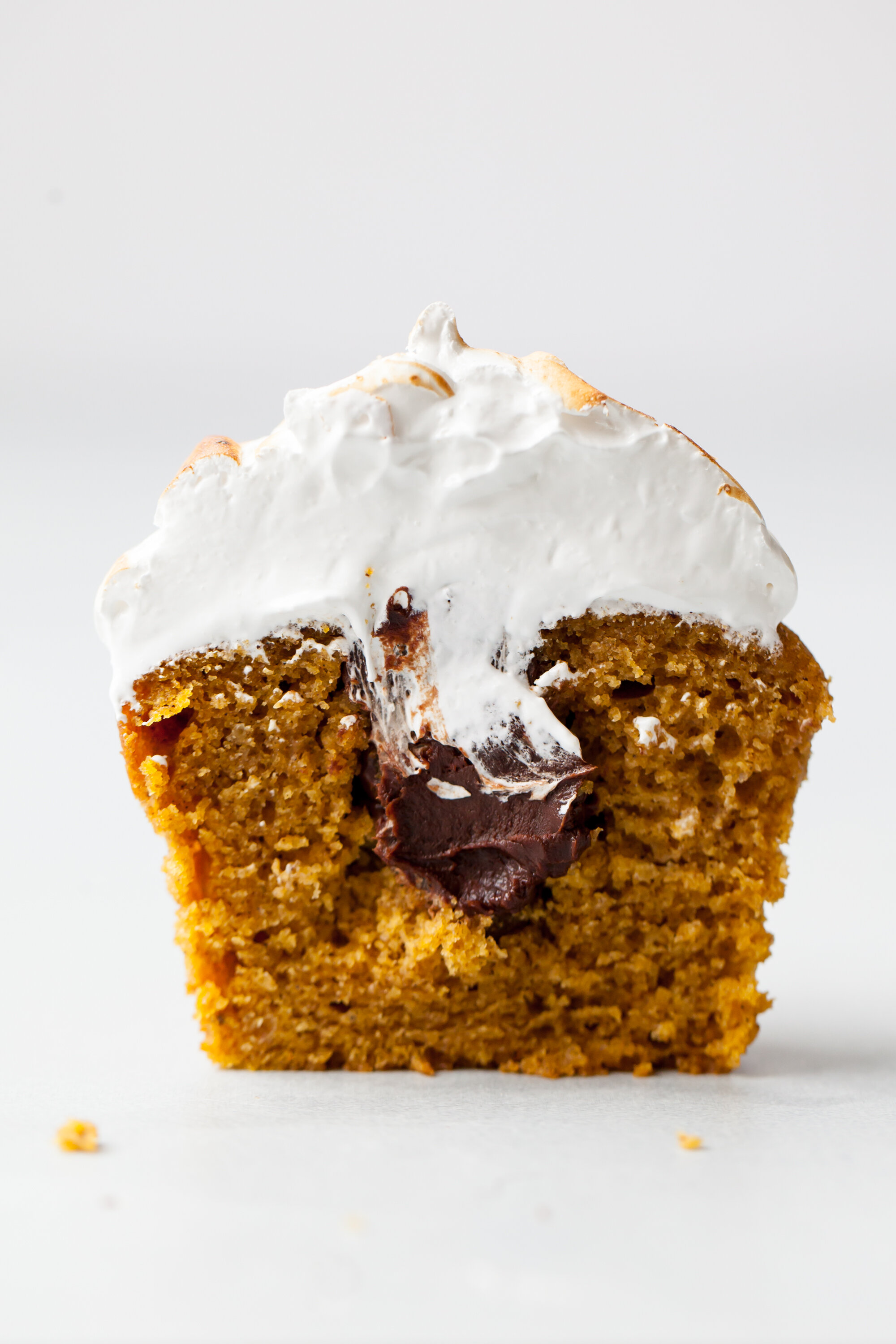 Pumpkin S’mores Cupcakes with ganache filling and toasted meringue topping.