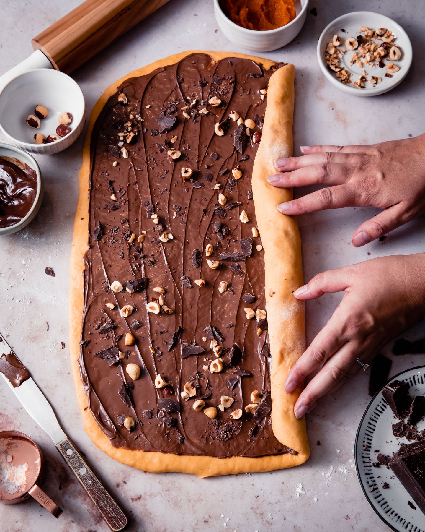 Rolling up chocolate-filled pumpkin babka dough