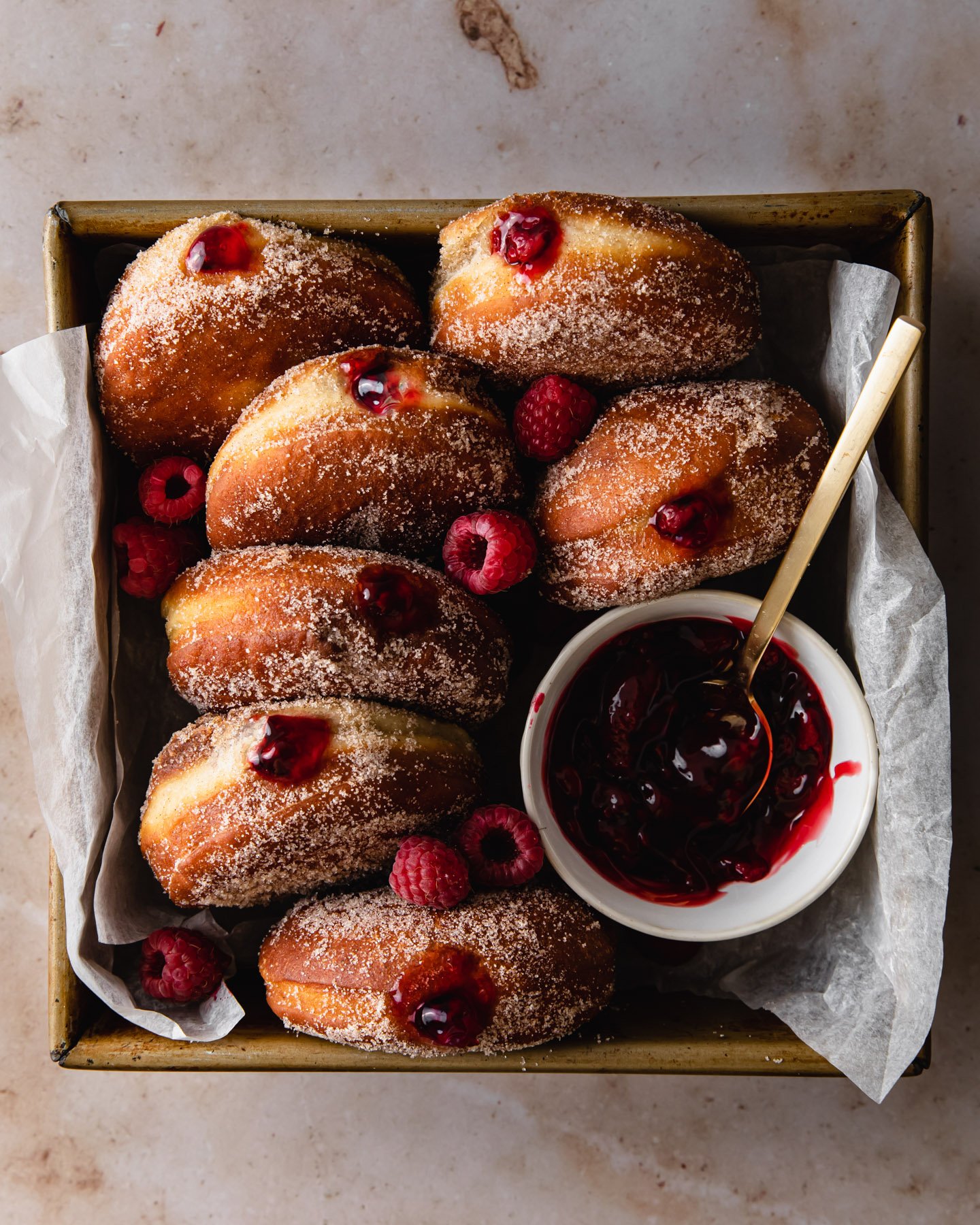 Raspberry filled brioche donuts