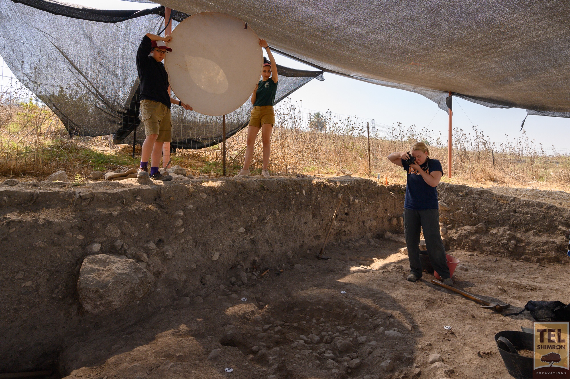 Val, a member of the GIS team, prepares to map a feature in Grid 94