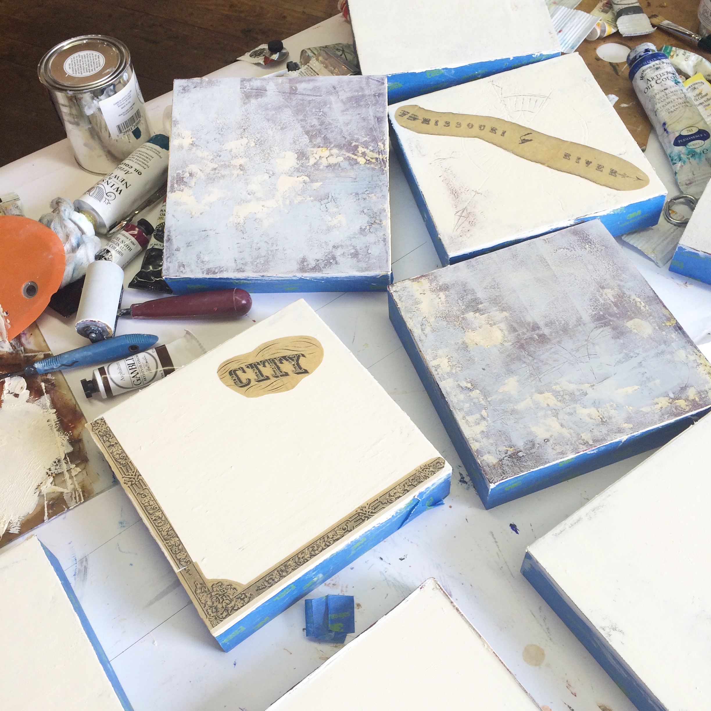 about 10 panels in various stages of layering, collaging and other interventions. 