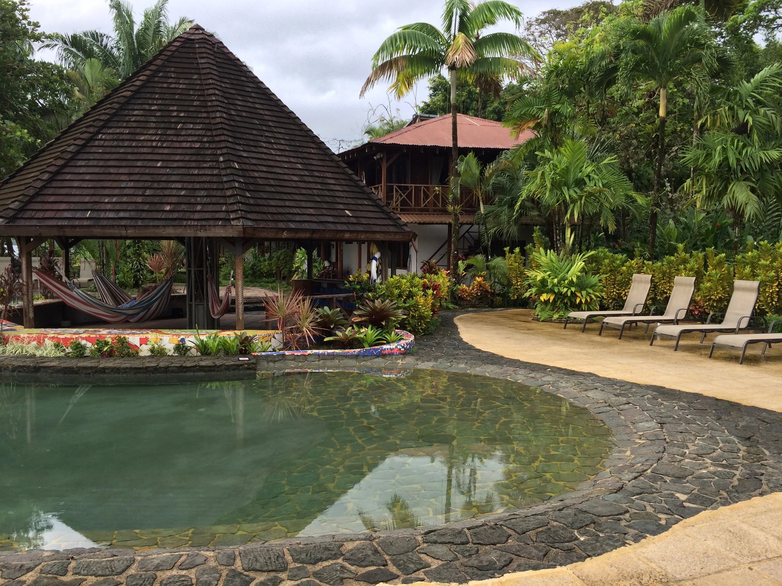 the pool, hammocks and lounge chairs face the canal
