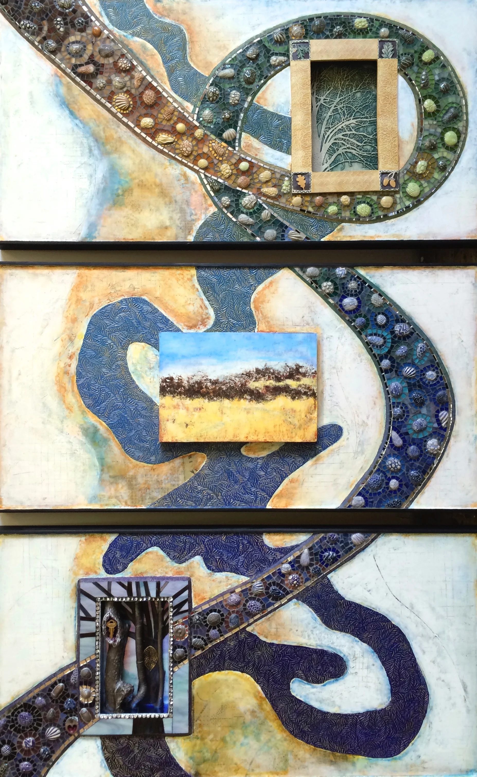 "Rivers, Roads, Remains" is a 3-panel (each 20" x 40") mixed-media artwork, portraying ideas connected to the Missouri River. It includes old maps, found objects and the mosaic path echoes the line of the Bob Kerrey bridge that links Omaha and Council Bluffs. 