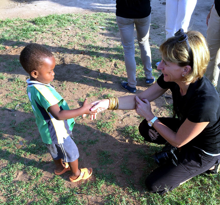 A young Ugandan child meets Paula Resnick during her trip with Innovation Africa.