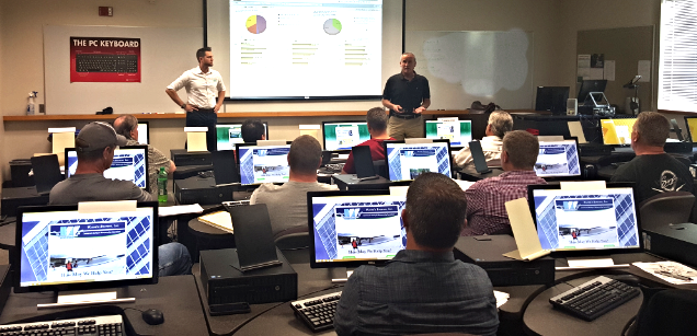 Above: Ryan Groth, President of FollowUp Power and Don Guthrie, President of Wayne's Roofing, Inc. work together to help train the Wayne's Roofing team on the new program.