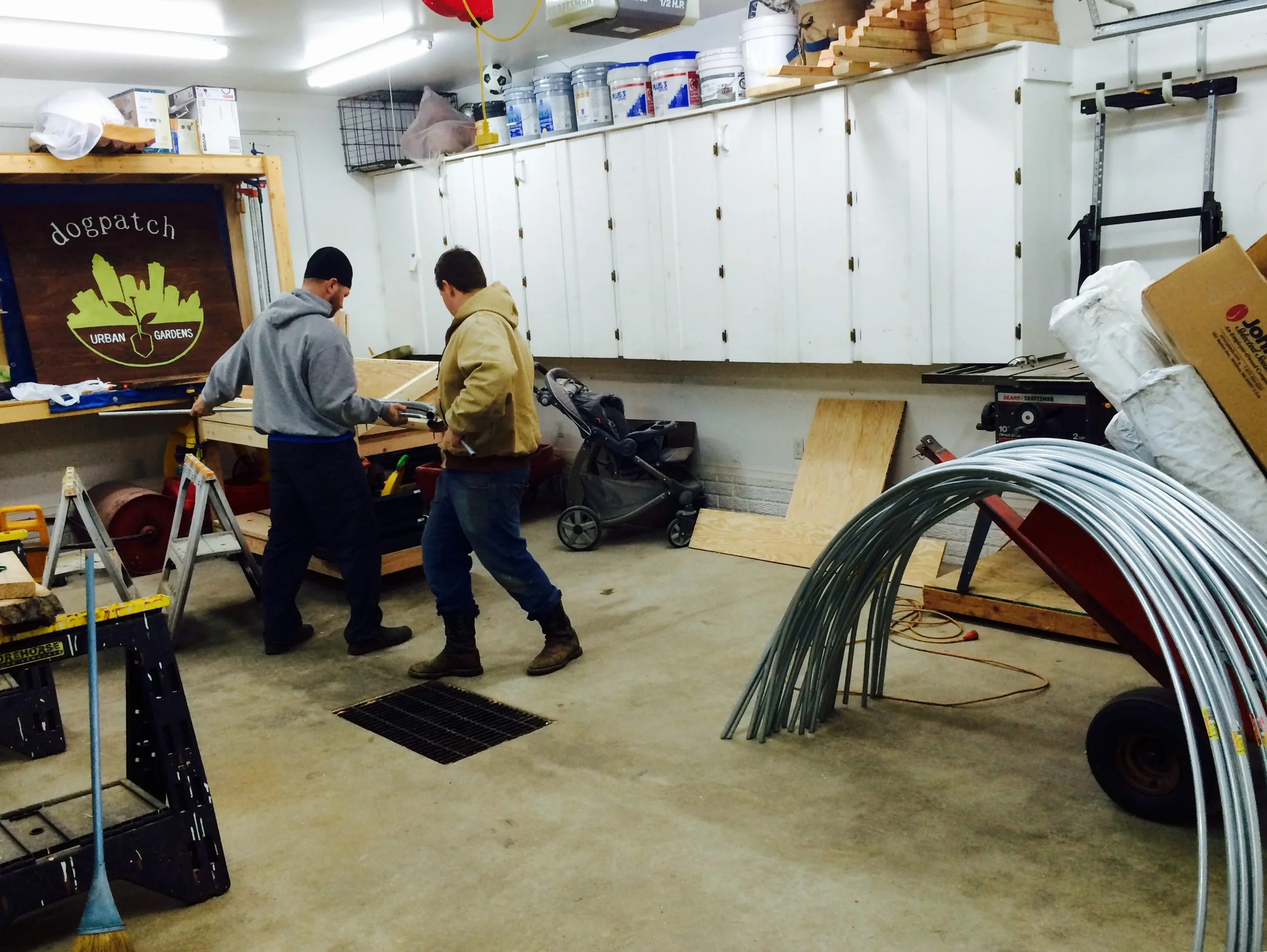 Eric and Lucas bending hoops for low tunnels (and a sneak peak at the sign)