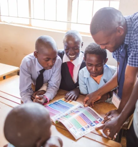 day1-zambia-ksw-boyslookingbook.jpg