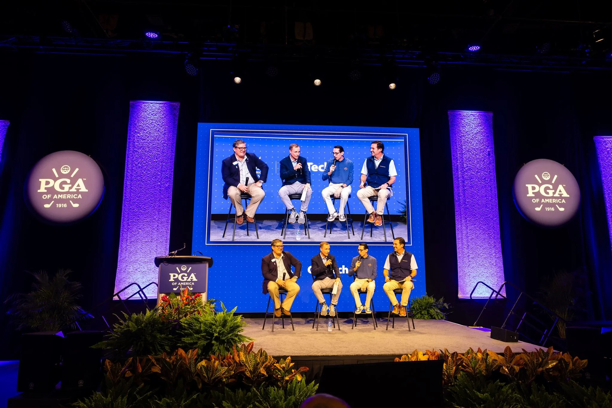 Panel speakers on stage during a corporate conference photographed by Dreamscape Photography + Video in Orlando, Florida.