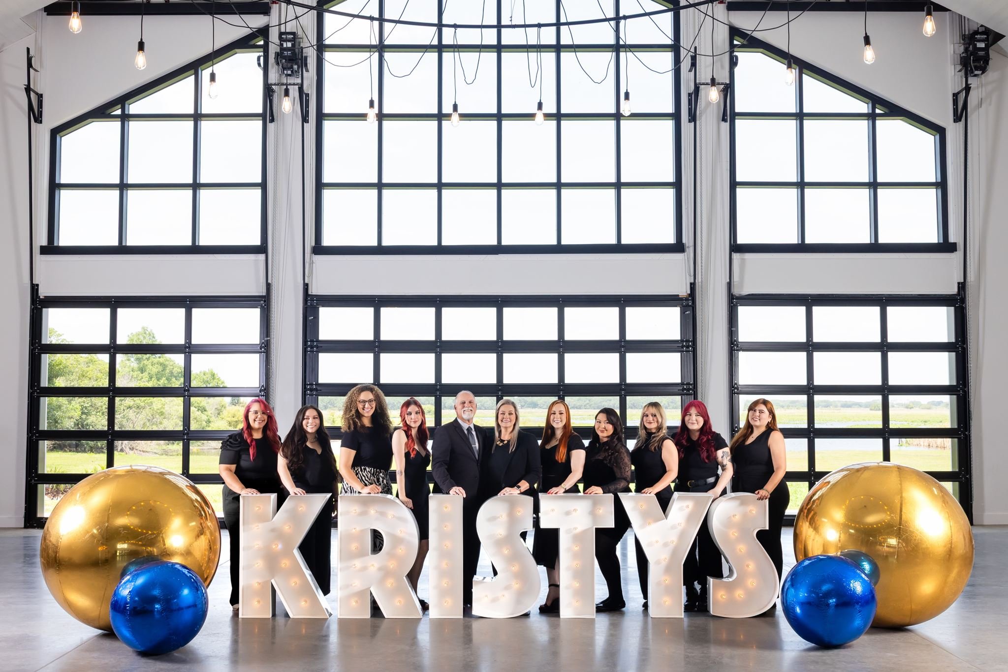 Professional team photo at a branded corporate event photographed by Dreamscape Photography + Video in Central Florida.