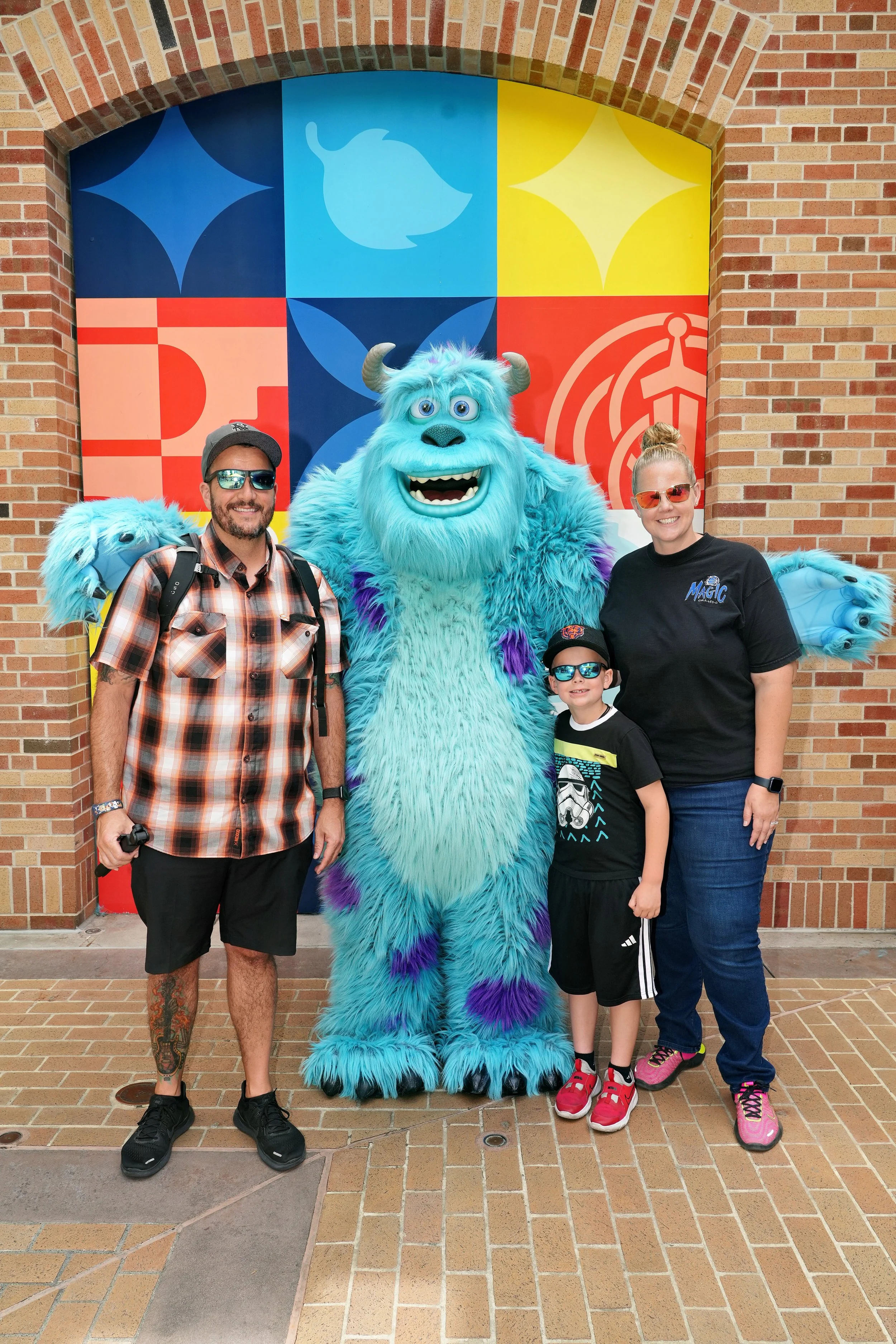 The family behind Dreamscape Photography enjoying a fun theme park day together with a colorful character.