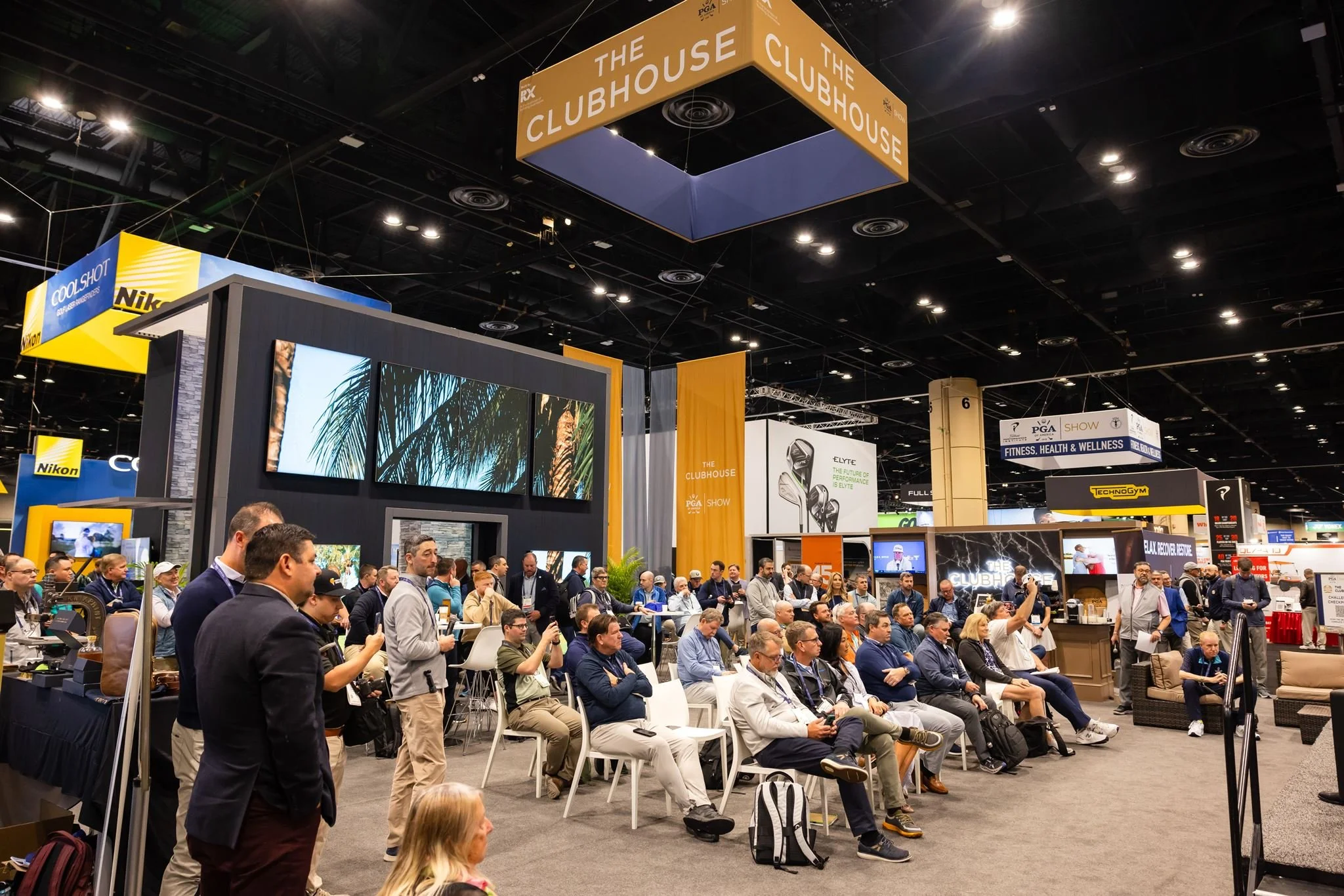 Trade show crowd gathered for a presentation at a corporate event photographed by Dreamscape Photography + Video in Orlando, Florida.