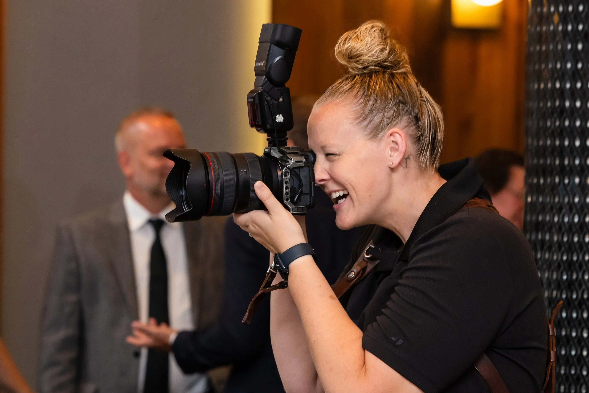 Nicole of Dreamscape Photography + Video smiling while photographing an event in Central Florida.