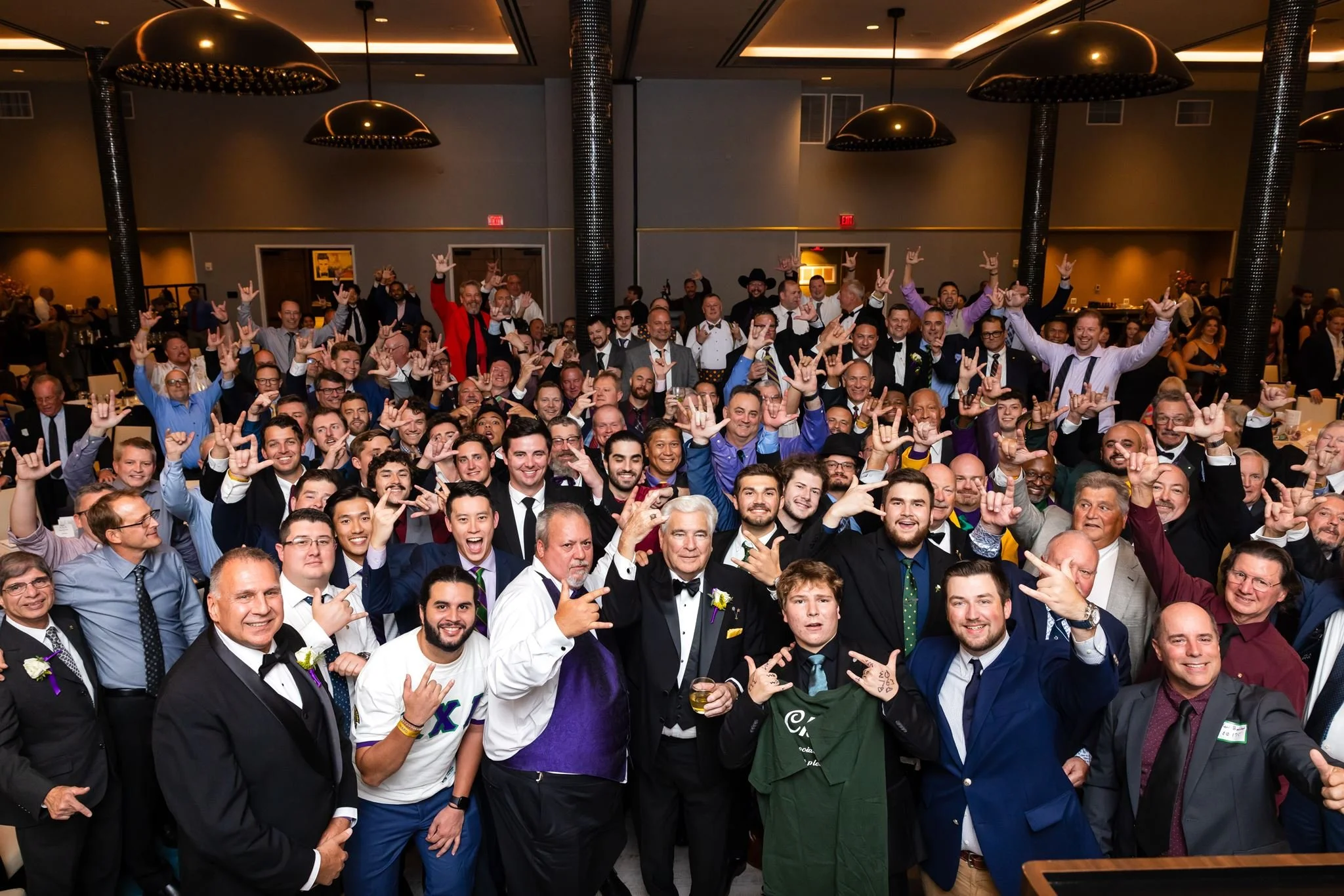 Large group photo at an indoor banquet event photographed by Dreamscape Photography + Video in Central Florida.