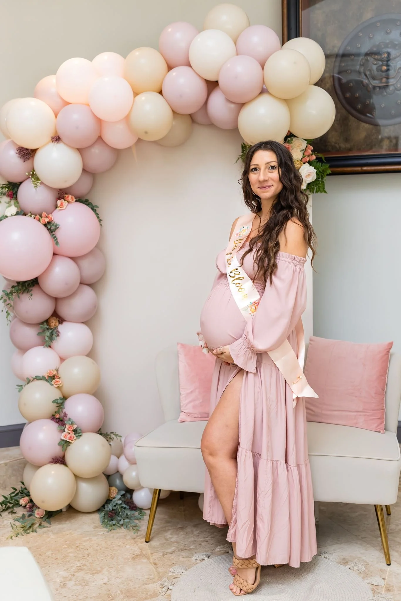 Expecting mother photographed at a baby shower with balloon decor by Dreamscape Photography + Video in Central Florida.