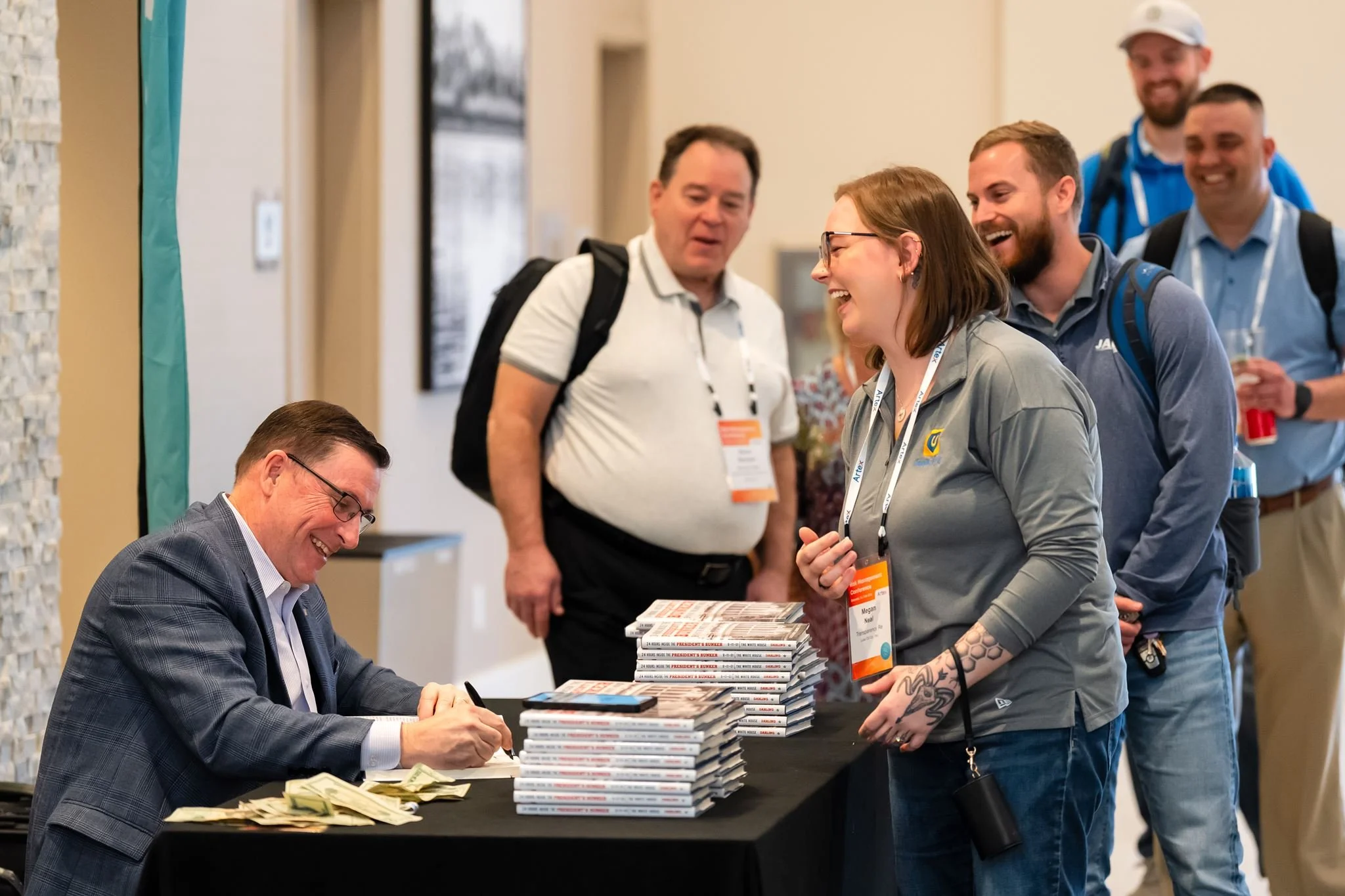 Candid attendee interaction during a corporate event photographed by Dreamscape Photography + Video in Central Florida.