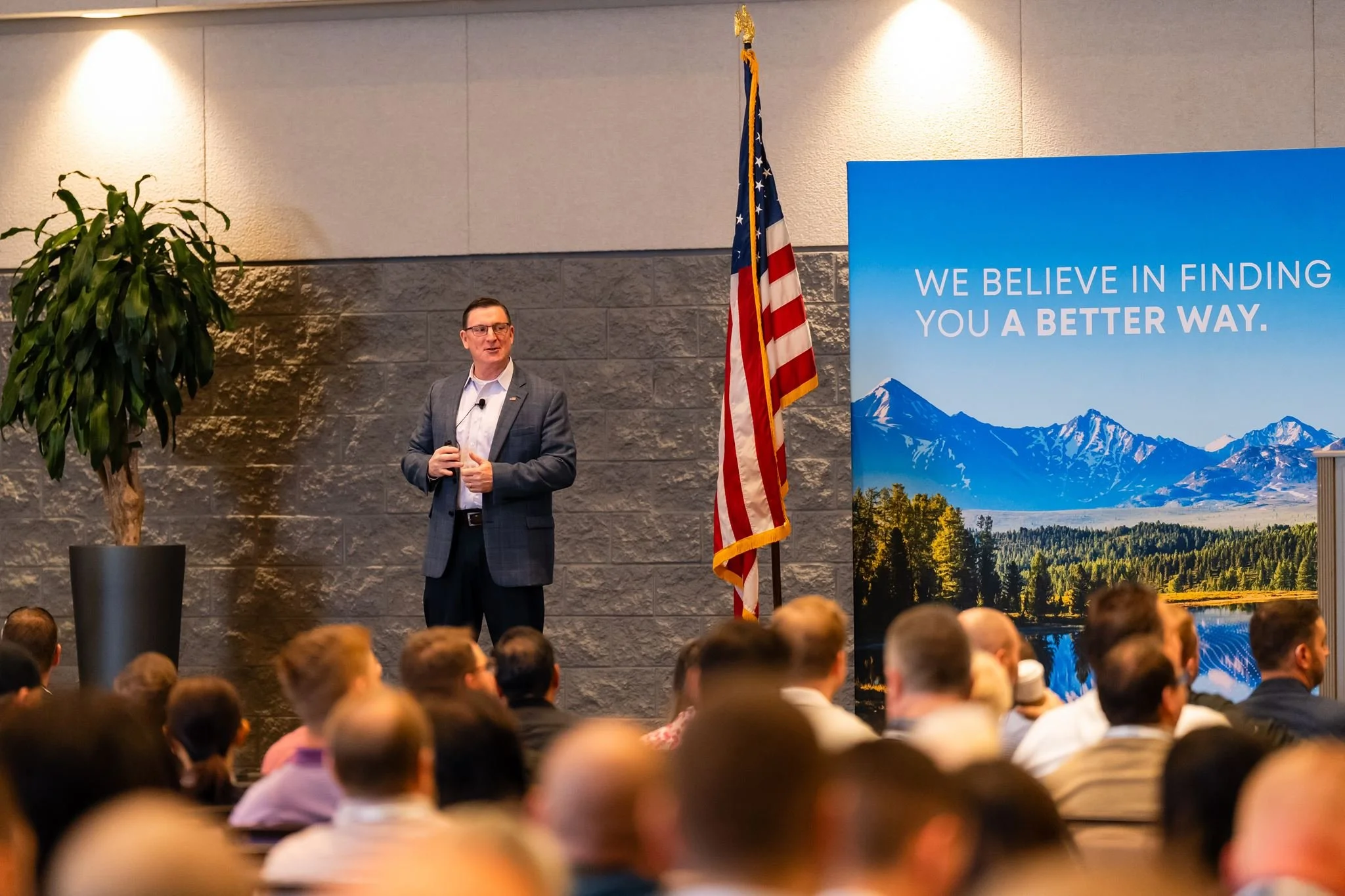 Corporate event speaker photographed in front of an audience by Dreamscape Photography in Central Florida.