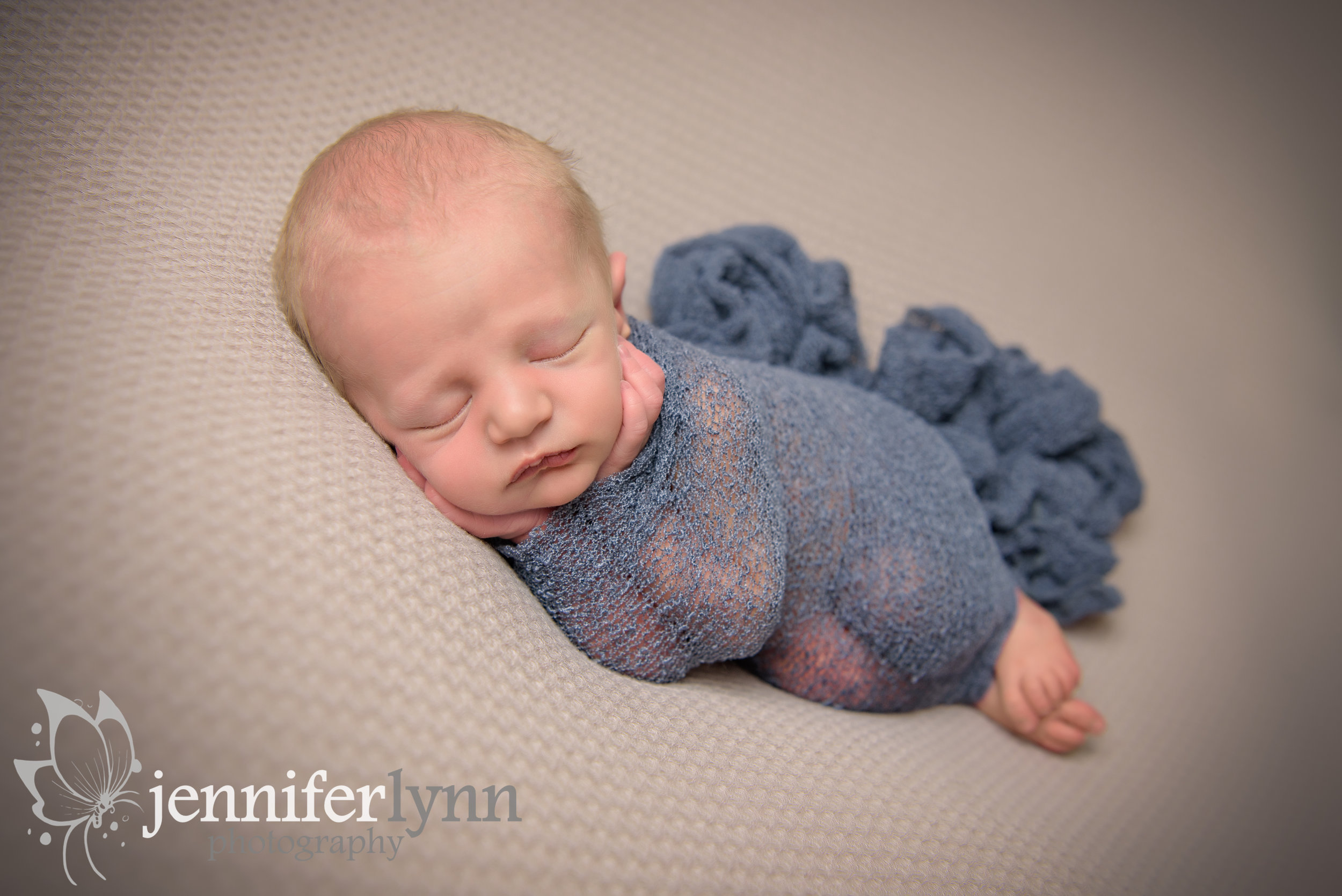 Side Laying Newborn in Denium Wrap