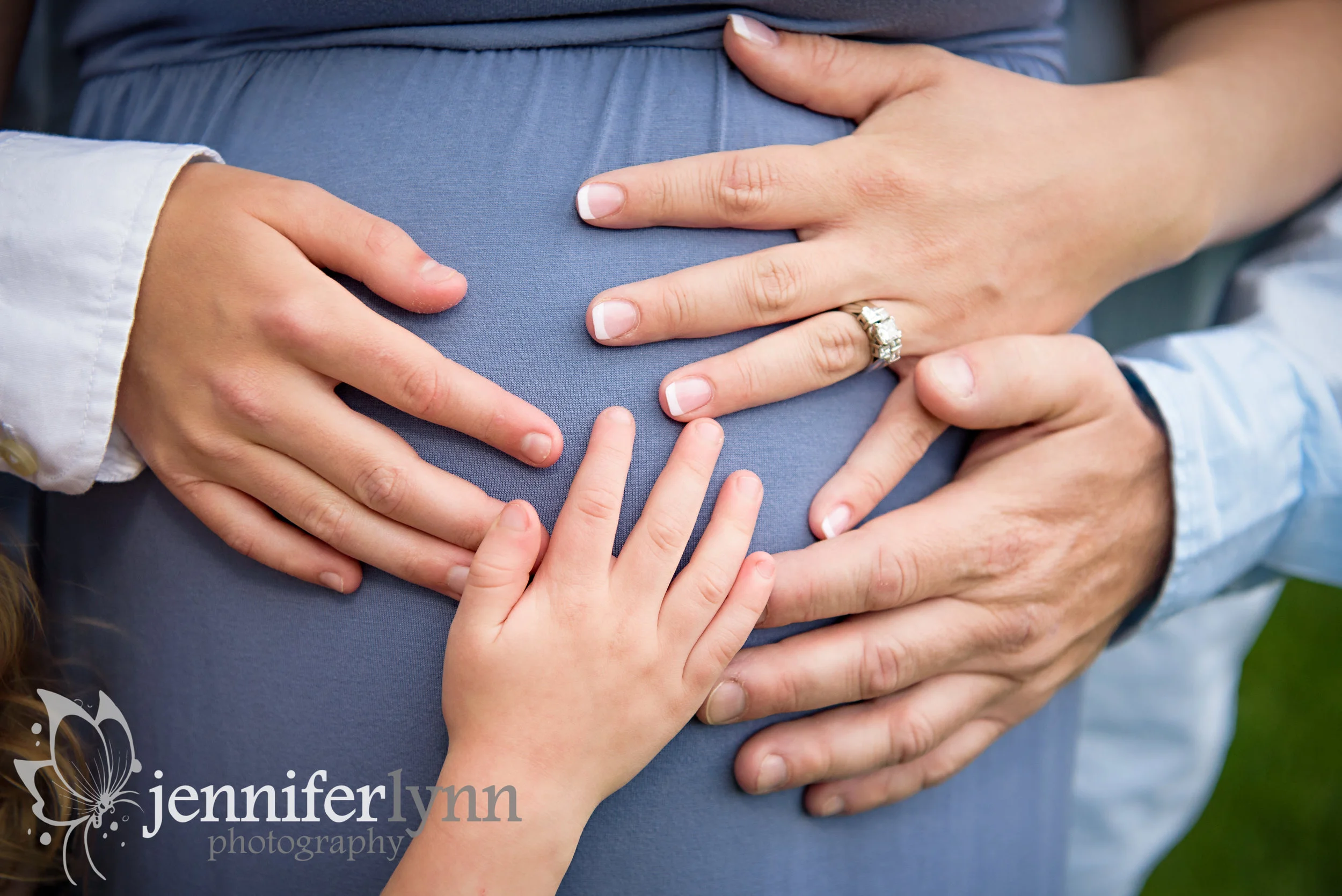 Hands of Family Members on Baby Bump