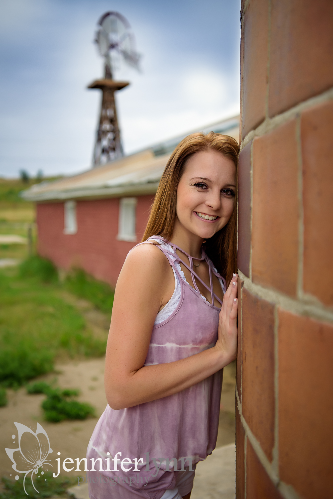 Senior Girl Barn Red Brick Leaning