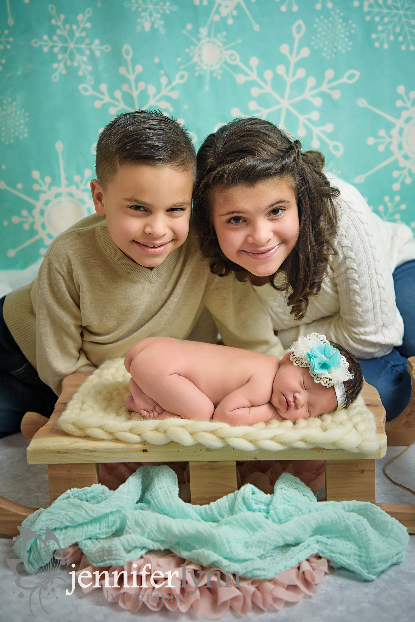 Sibling With Newborn Sister on Sled