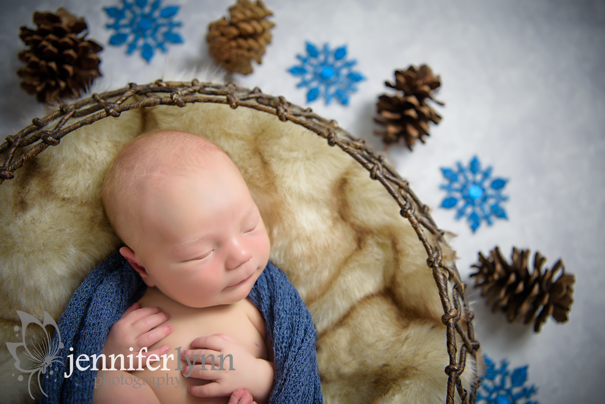 Close up of newborn boy pinecones snowflakes