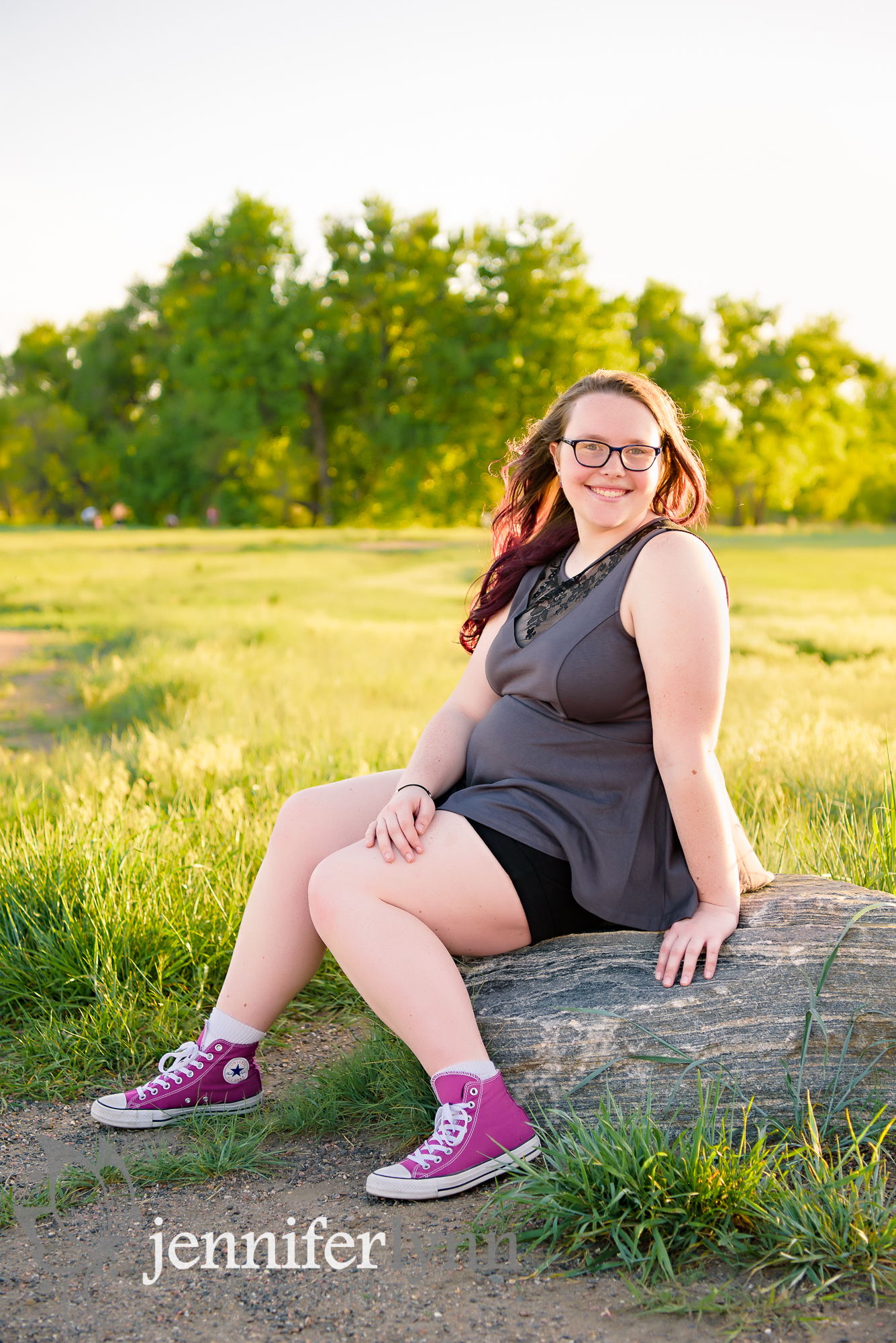 Senior Girl Sitting Rock in Sun