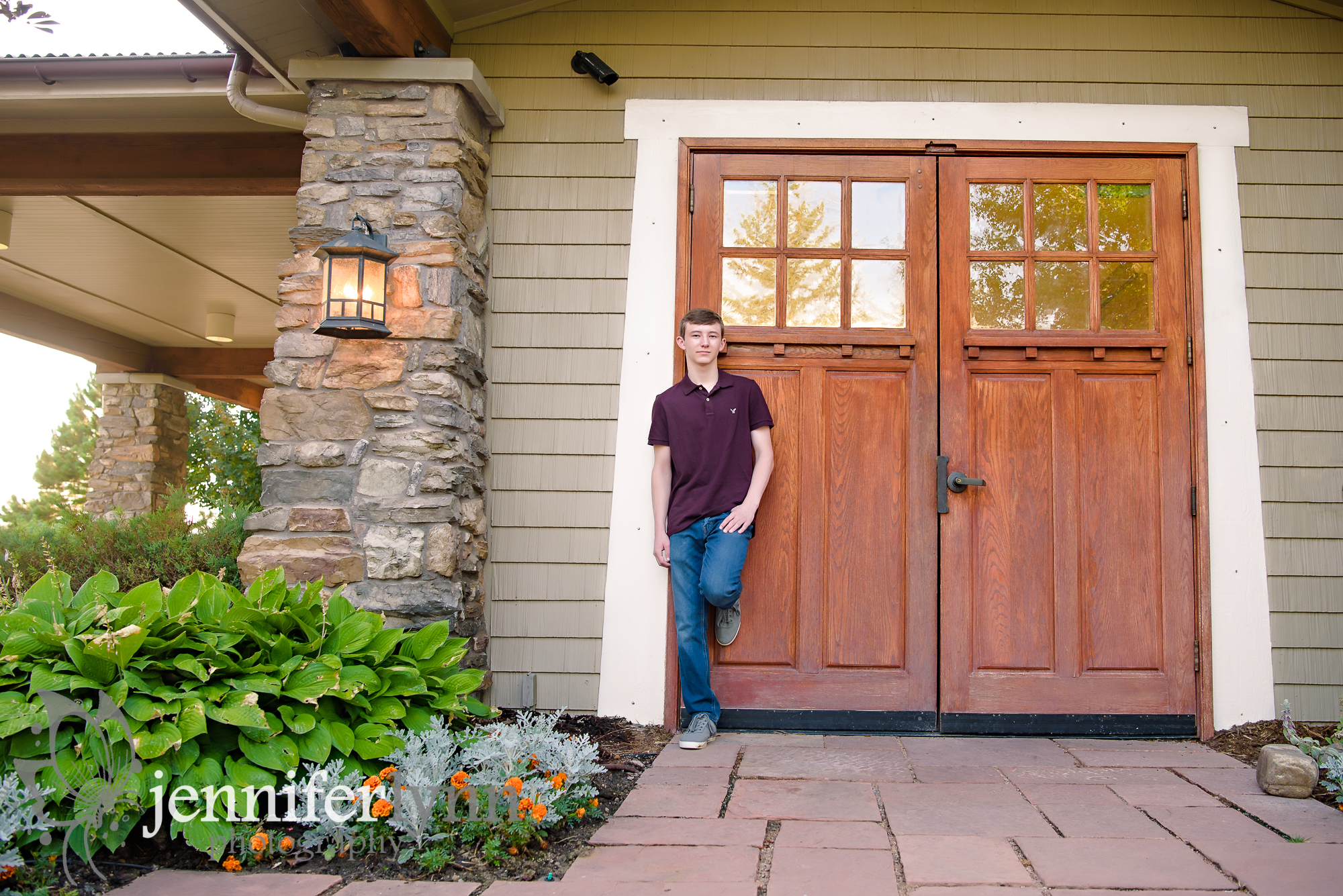 Senior Boy Leaning Back on Big Wooden Door