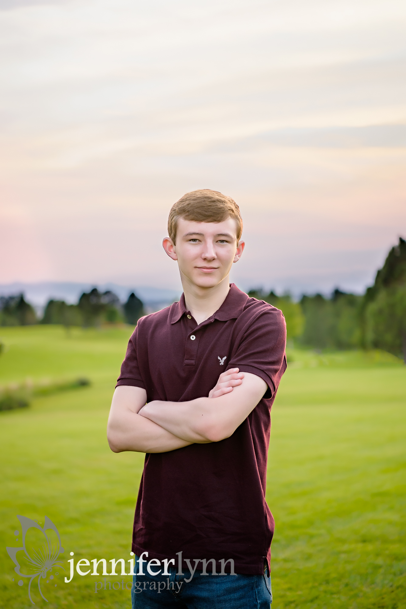 Senior Boy Stands Arms Crossed Mountains Sunset
