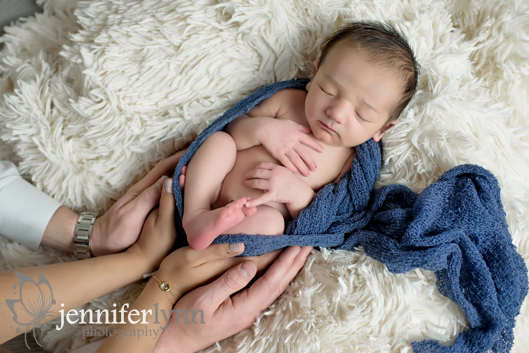 Newborn Boy Wrap with Parents Hands 