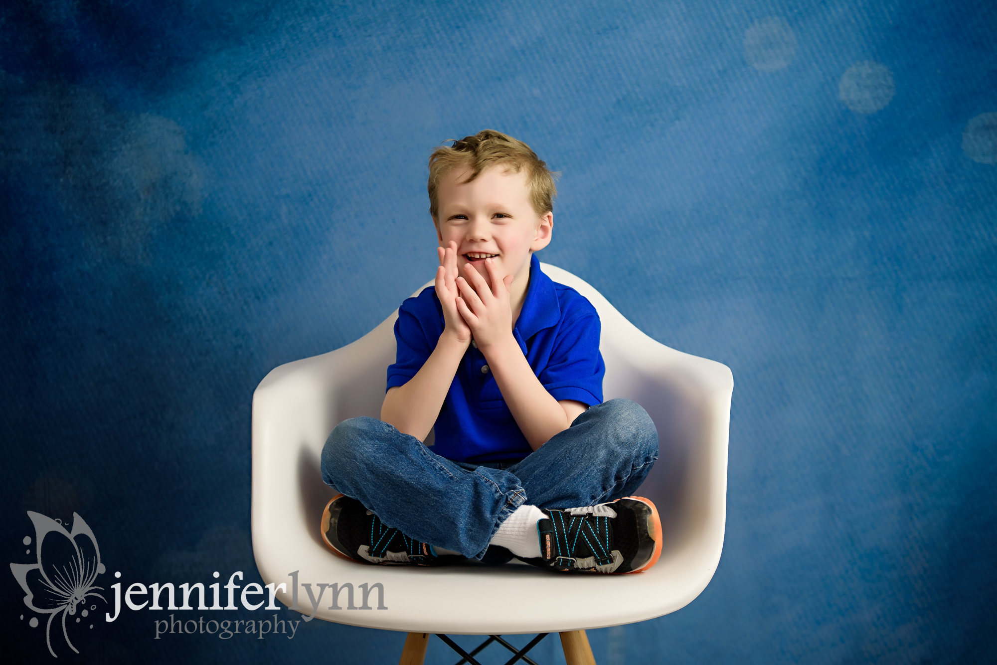 Young Boy White Chair Blue Background