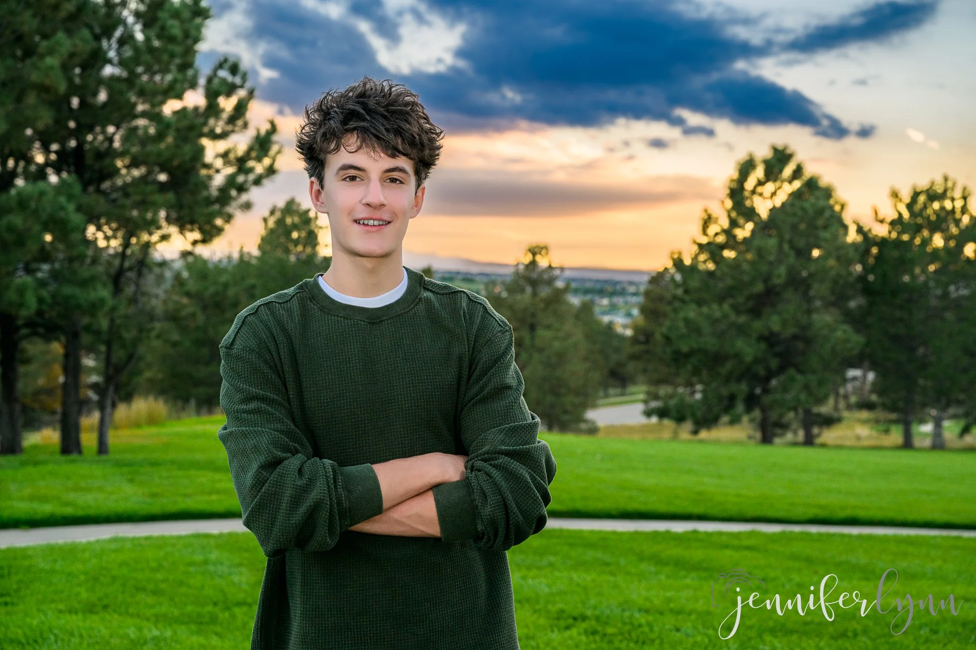 Matthew senior boy outside at summer Colorado location with sunset and Pike's Peak in the distance