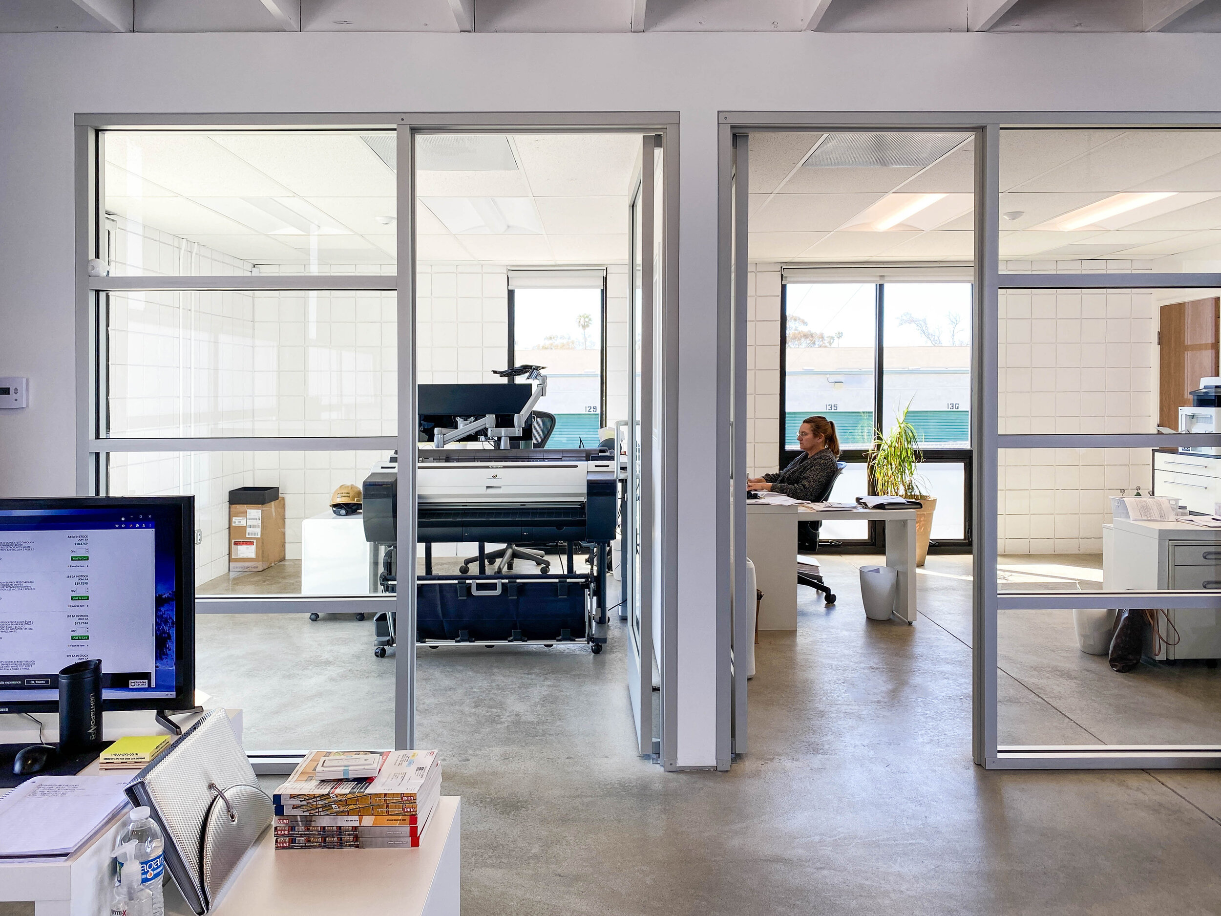 A profesional plotter printer seen through an open door