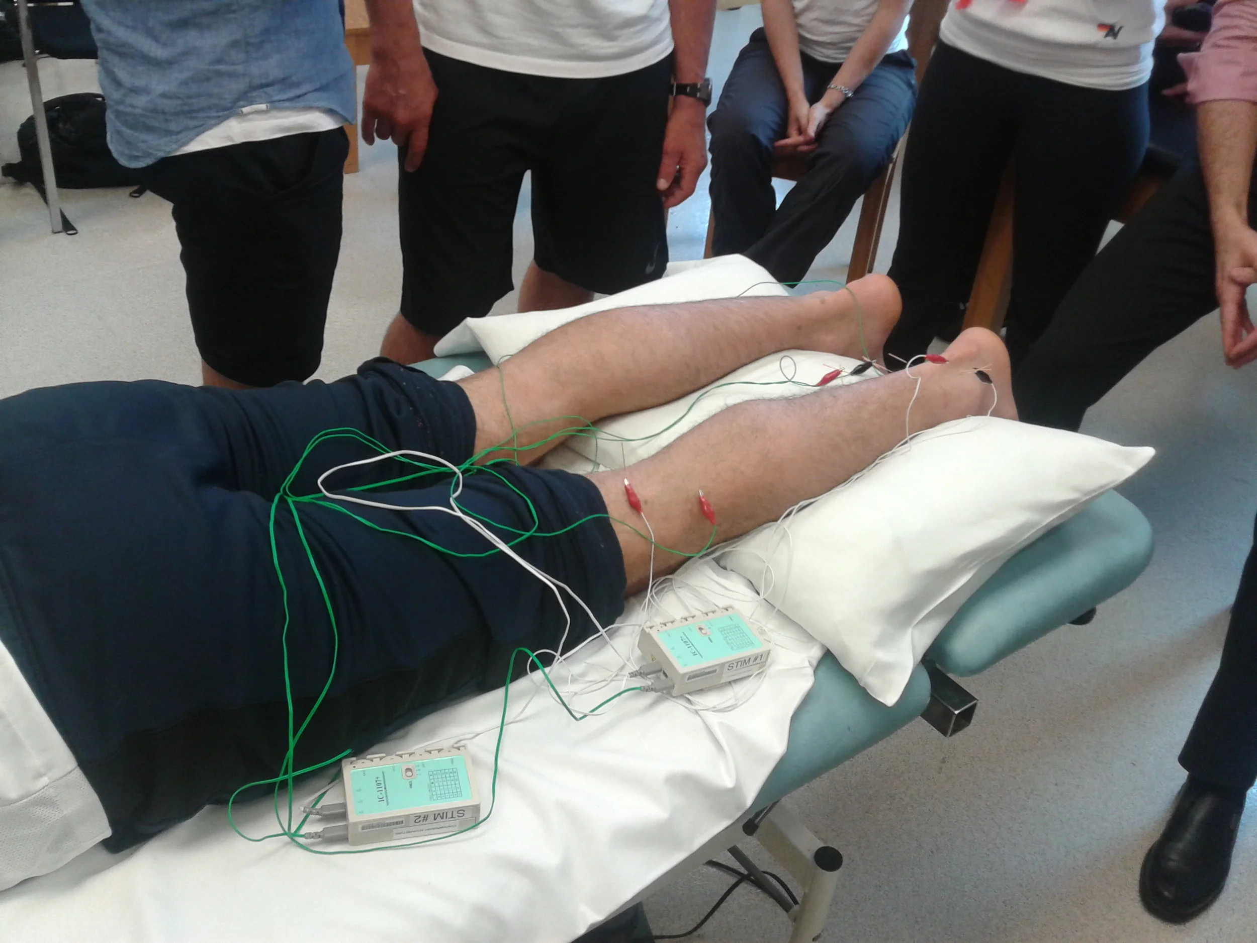 A demonstration of electro-acupuncture for a lower body injury