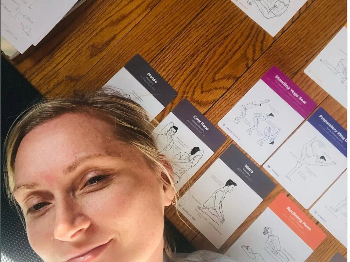 Jana Sutherland with yoga pose cards during her yoga teacher training