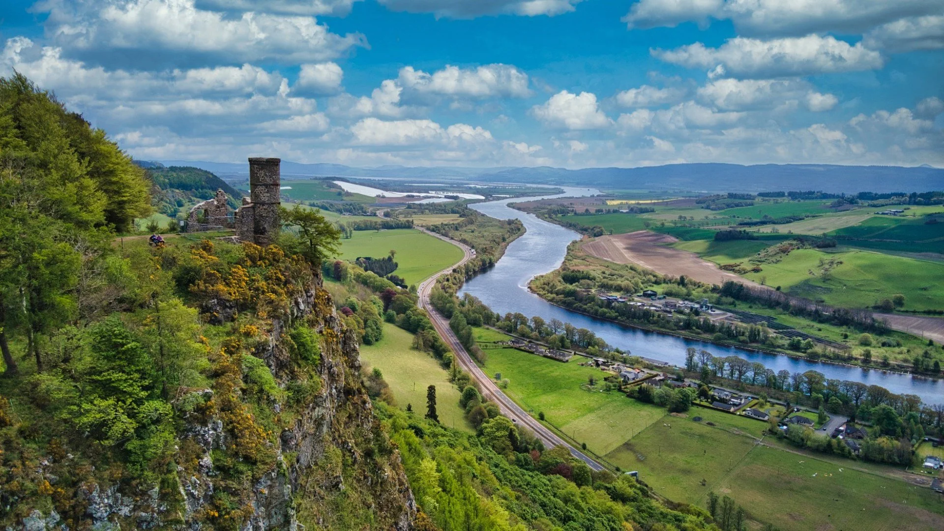 Wide view of a river winding through green countryside in Perthshire, Scotland