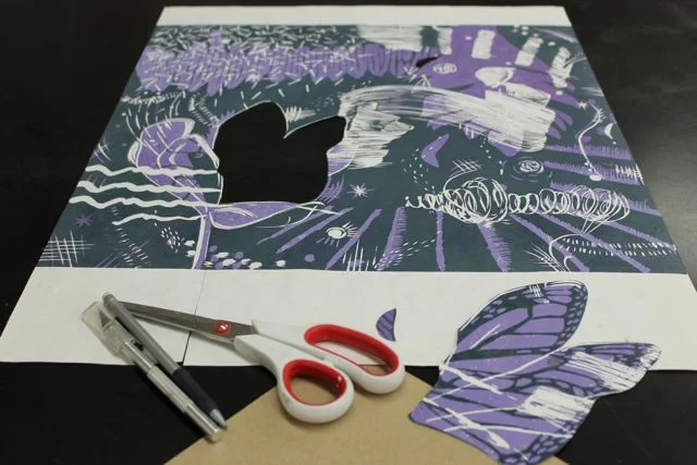 Take a preferably dry print and cut out the shape you want to add into the print. I decided I wanted the wings and a small semi-circle to be added in paper to my print.