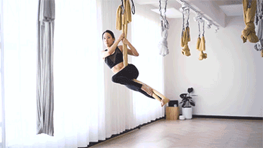 Aerial Yogi Flying in Golden Silk at Little Mandarin GIF