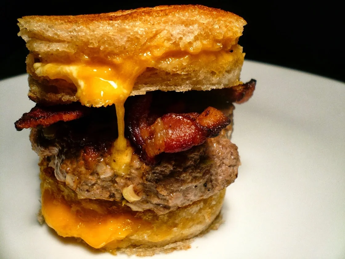 sourdough grilled cheese sandwich burger with bacon and tomato