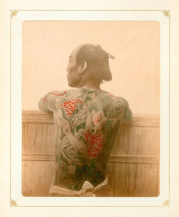 Late 19th-early 20th century image of a man with a Japanese style tattoo.