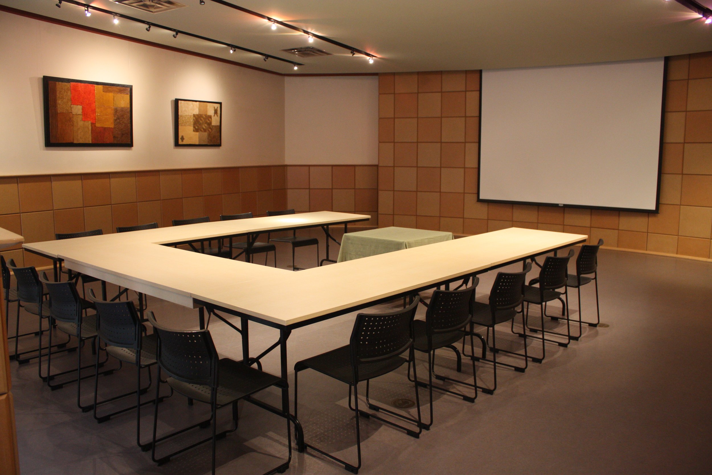  The visitors’ centre set up for a meeting with three long tables forming a ‘U’ shape in front of a projector screen 